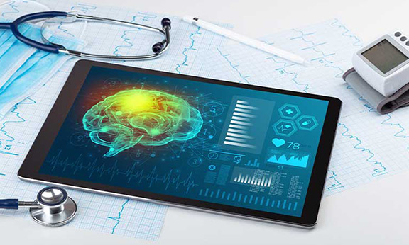 Tablet displaying a digital brain scan, health metrics, and stethoscope on medical charts