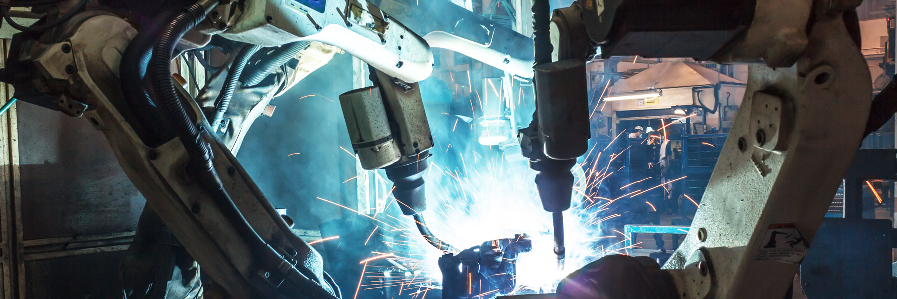 Cobots in a factory with sparks flying